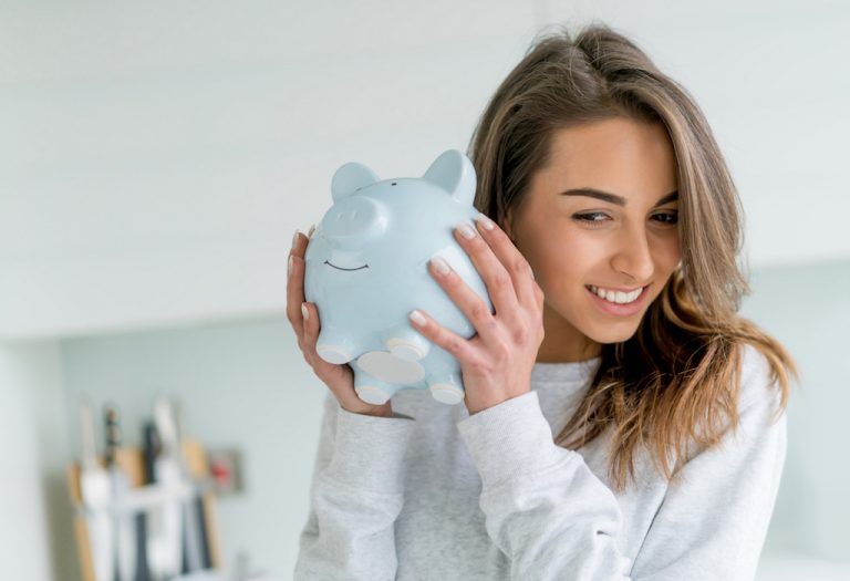Happy young woman saving money