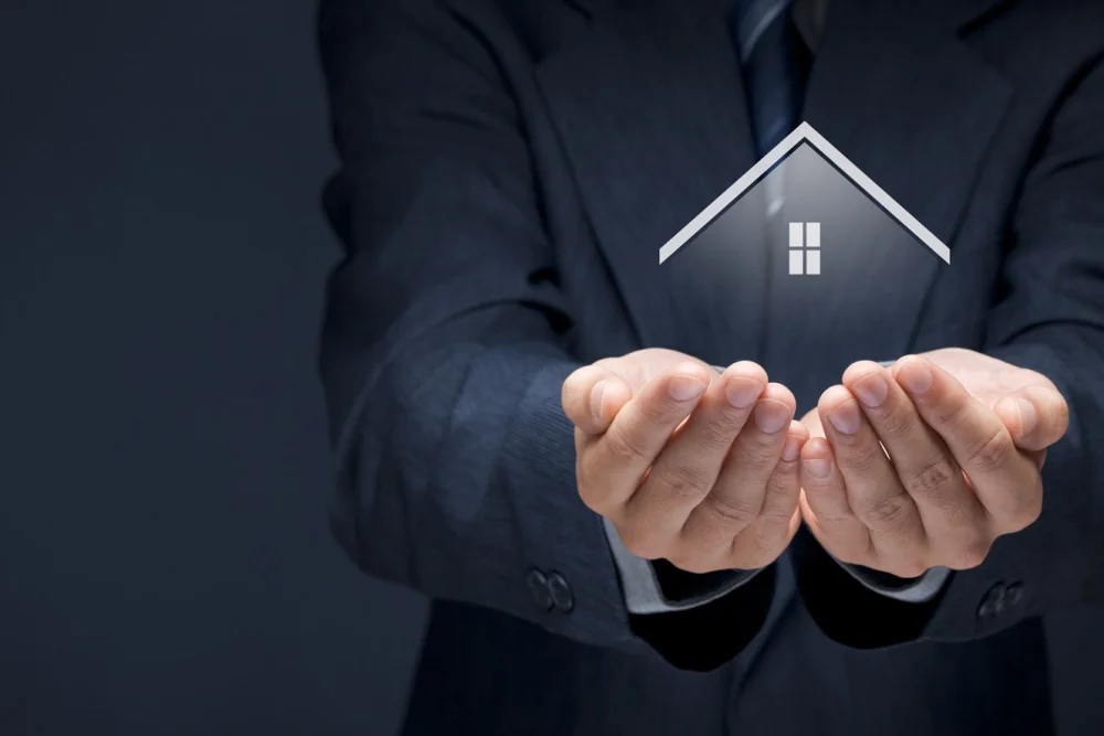 Hands holding a house, Help to Buy vs the 5% Deposit Scheme ownership and loan size compared